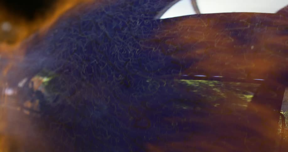 Blue glassware spinning under torch flames