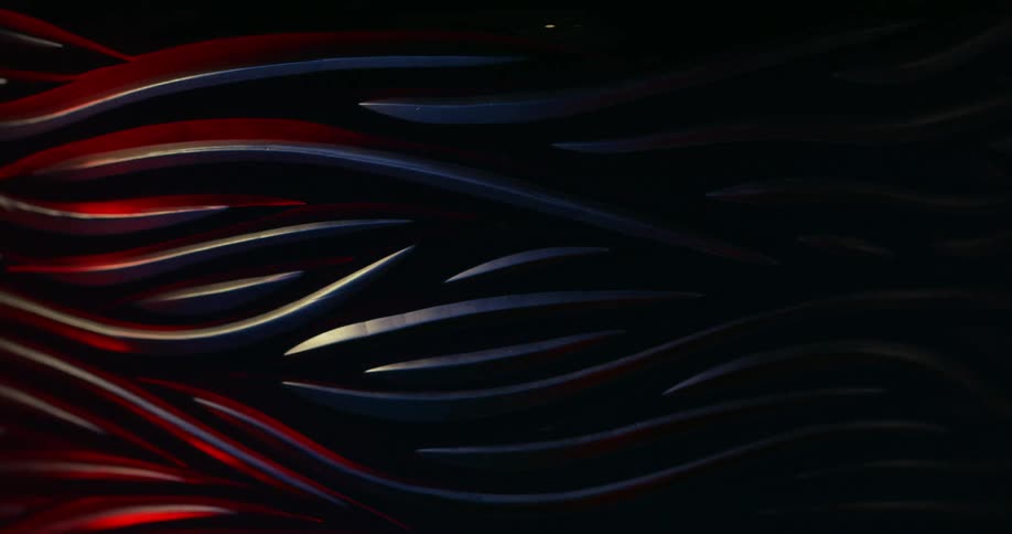 Abstract metallic object with purple and red lights passing through