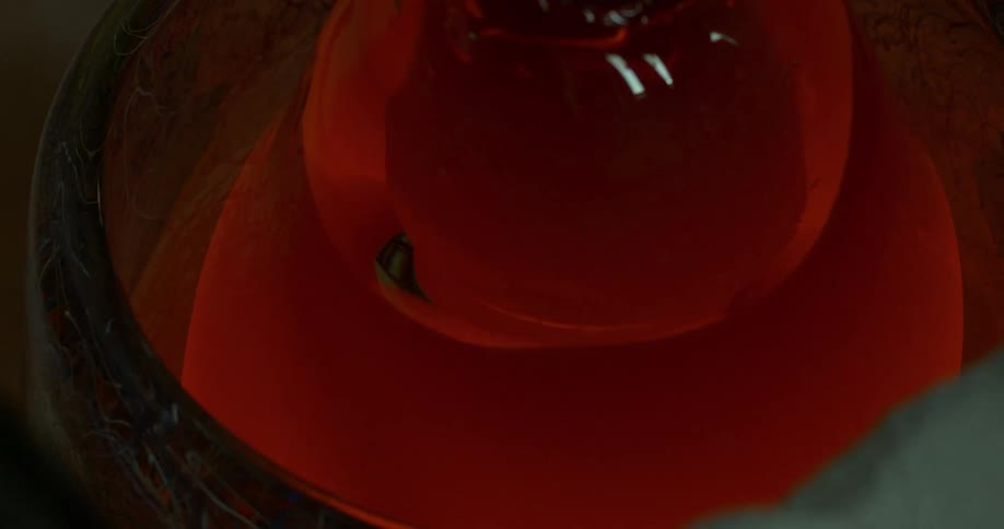 A red rose flower shape reflecting dim light