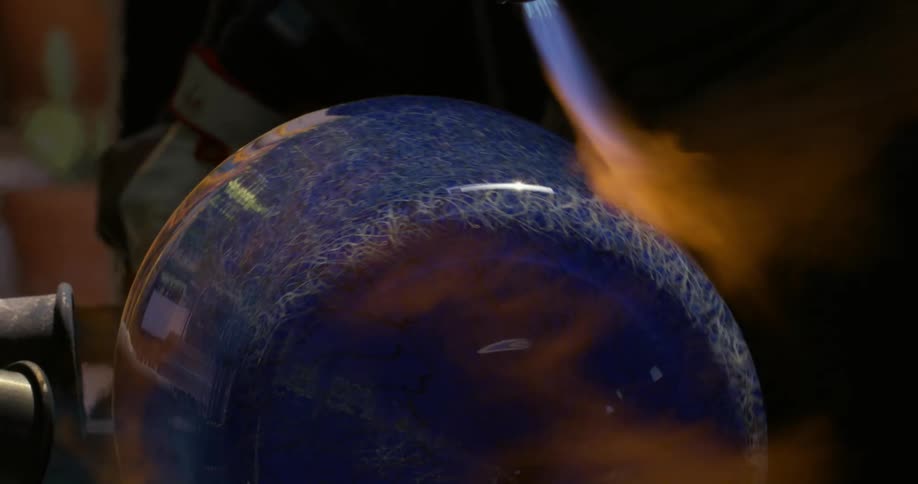The production of a ceramic vase with a torch being passed over it