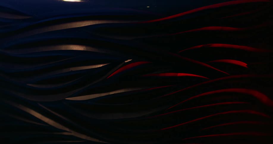 Objects shaped like red and blue lines being illuminated by light