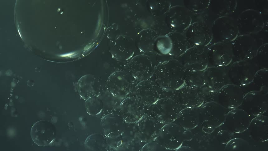 Abstract slowmotion footage of bubbles moving in a liquid