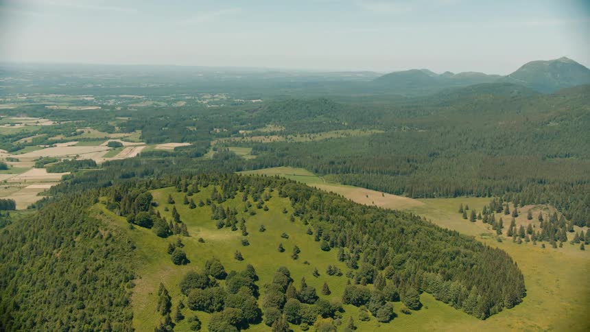 Aerial view of forested green mountain slope