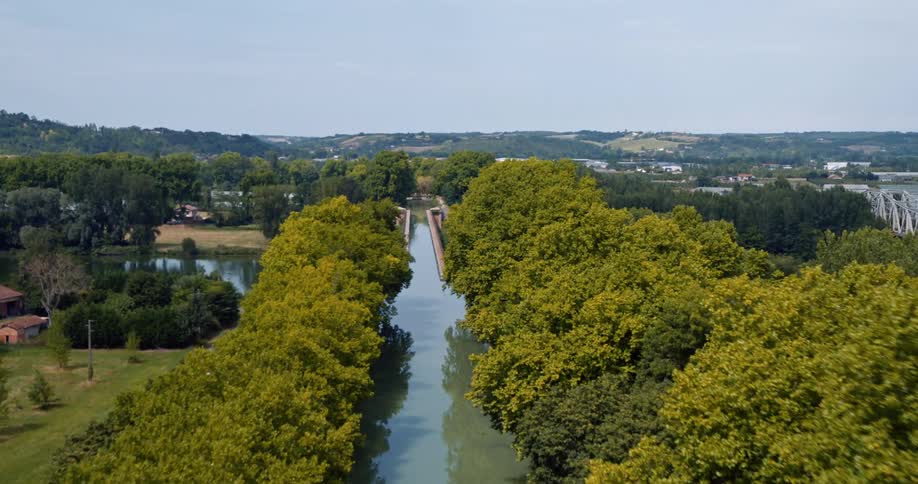 Aerial view of a watercourse through a town in the countryside