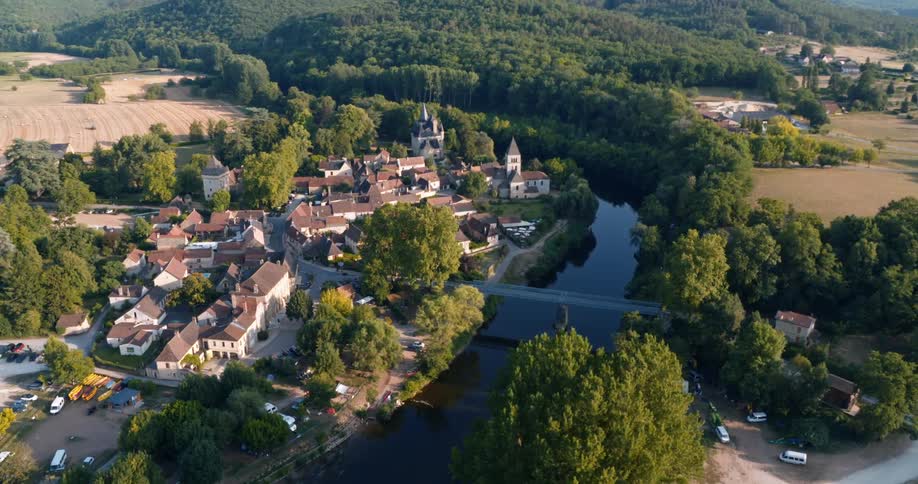 Aerial view of town and bridge over river near the mountain forest