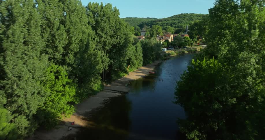 A river passing through a large forest in the countryside