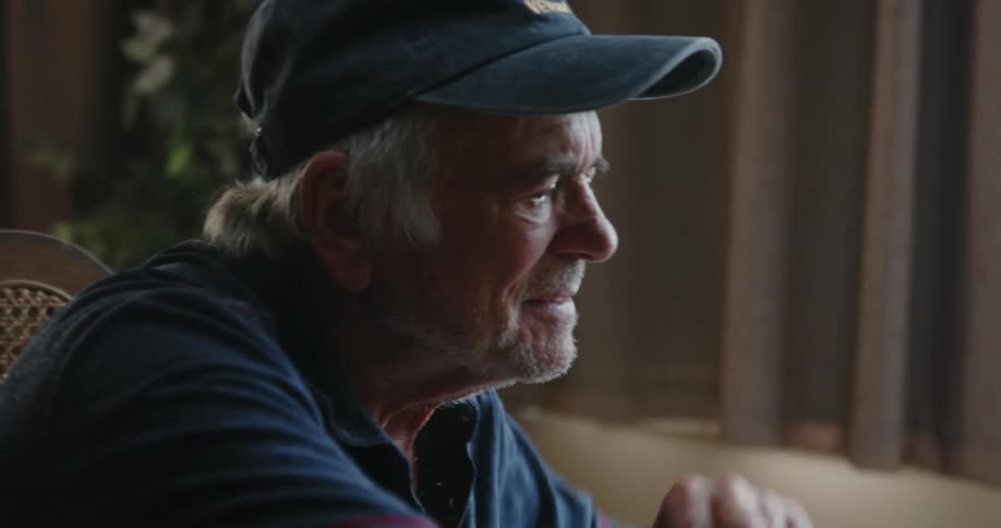 A man opens up a book at home