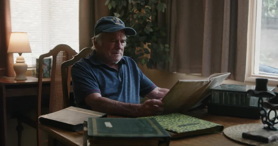 A man is flipping through a photo album