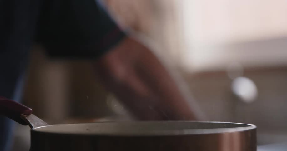 Steam rises from a pan on the kitchen