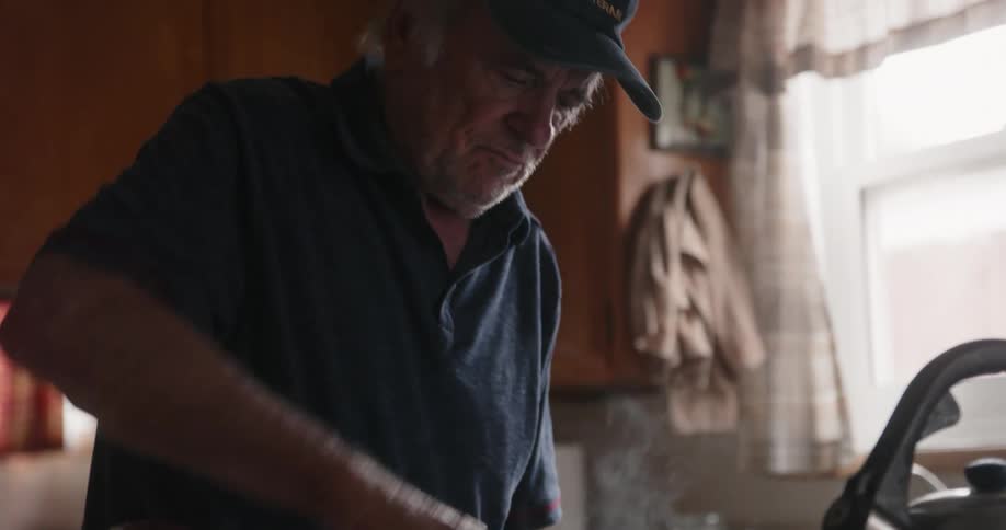 A man is cooking food on his stove