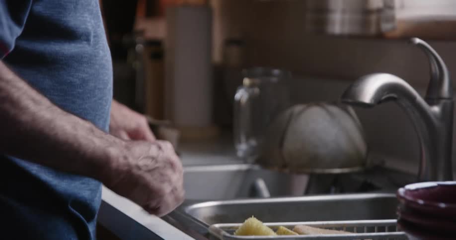 A man finishes up washing dishes