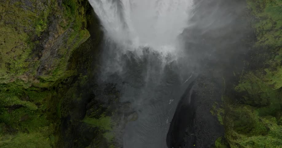 Waterfall over the rocks at midday