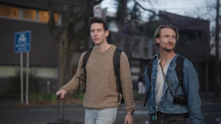 Two men walk through the city while on vacation