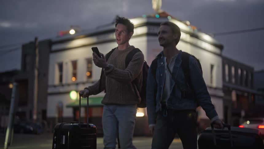 Two tourists walk through the city talking
