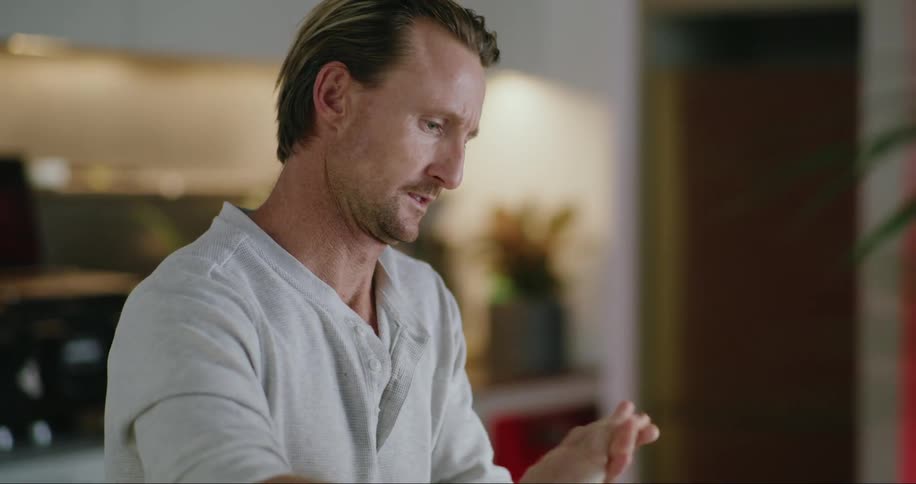 A man sitting at a table cleaning his hands with alcohol