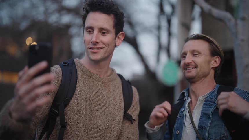 Two men talk on the cell phone