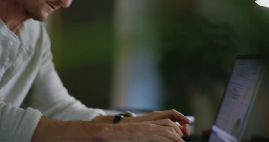 A man is thinking while he looks at his laptop