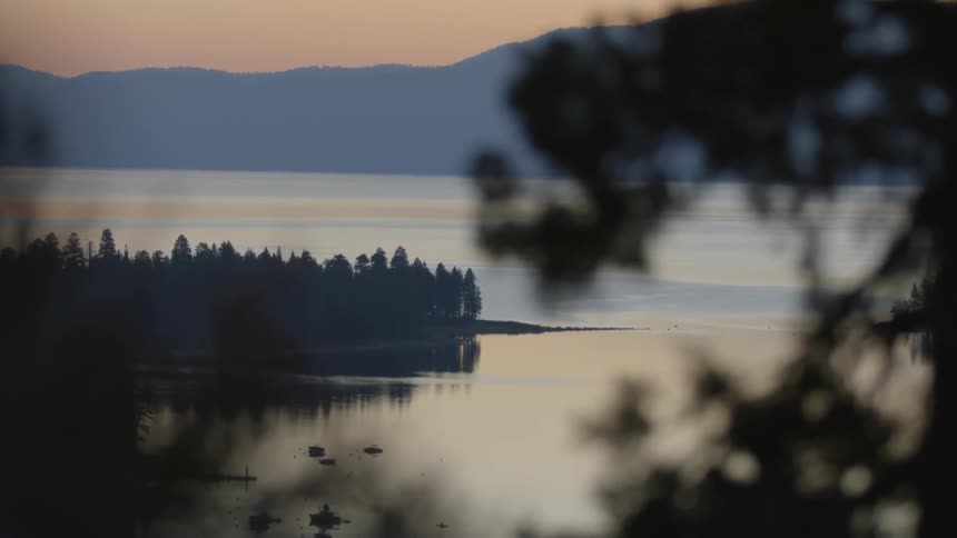 The water in this lake is calm at sunset
