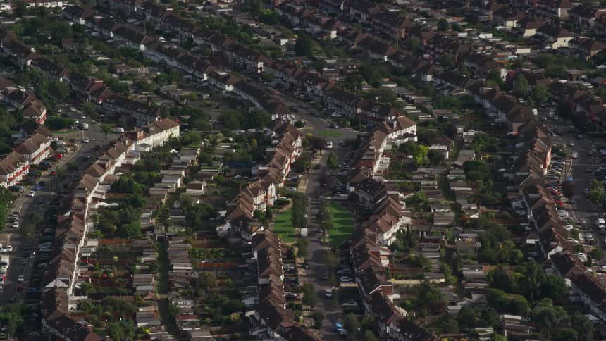 Aerial of trees and buildings in a suburban area on a sunny day