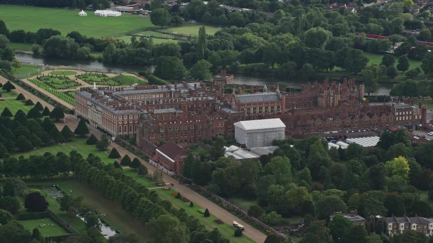 Aerial view of a large castle with extensive gardens in europe