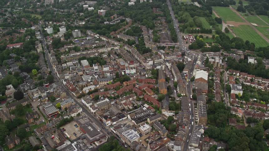 Aerial of trees and apartment buildings in a suburban area at midday