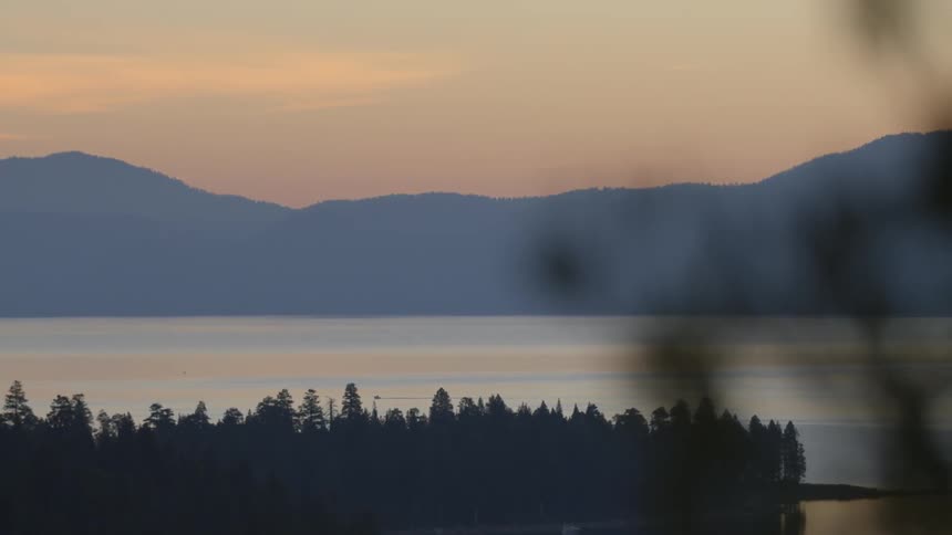 The sun is setting over the lake ahead