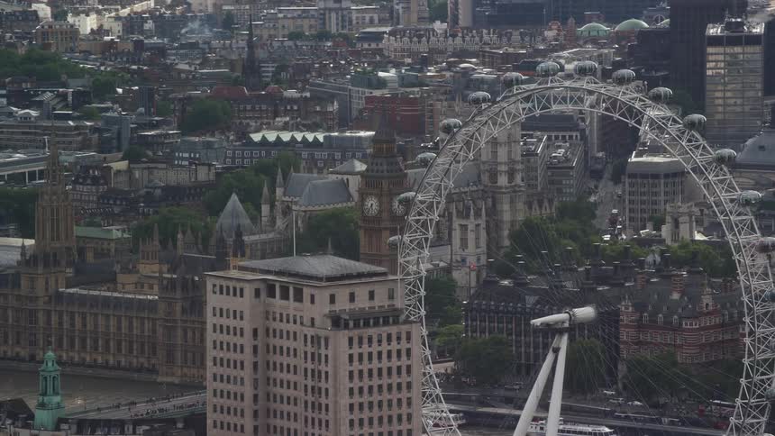 Aerial view of a metropolitan area with buildings churches and a white ferris wheel