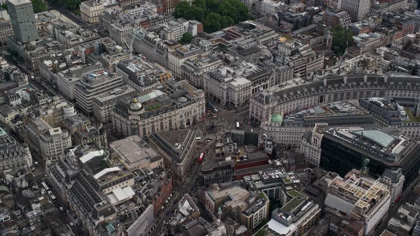 Aerial view of buildings and streets on metropolitan area surrounded by vegetation during day time