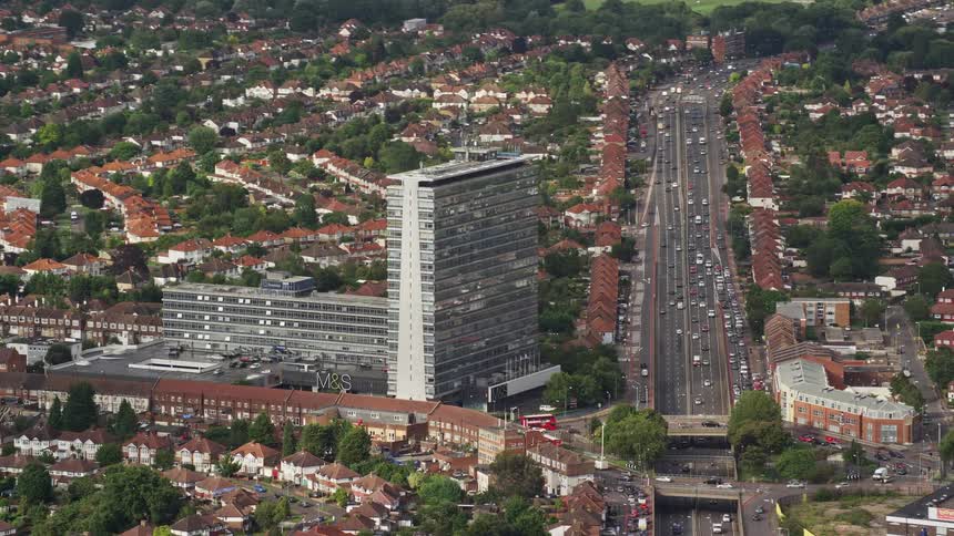 Road buildings and moving cars in an urban area at midday