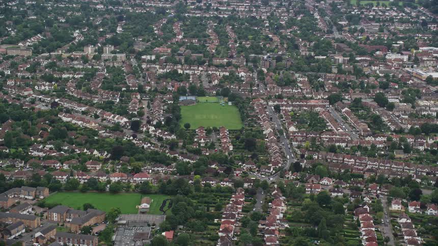 Aerial of buildings and trees in a city at midday