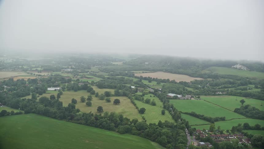 Low lying clouds cover rural town and nearby farms