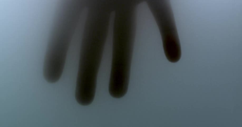 A hand in a fogged glass