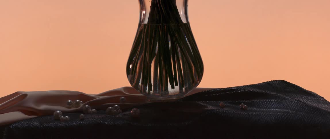 A vase full of plants is on the drape