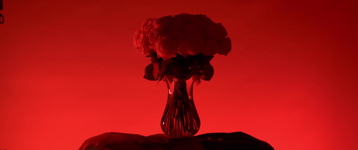 A flower inside a glass vase with water inside as the room changes color to reveal the flower