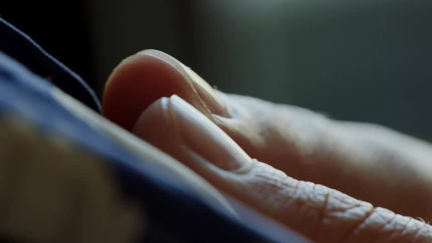 Closeup of fingers smoothing a fabric