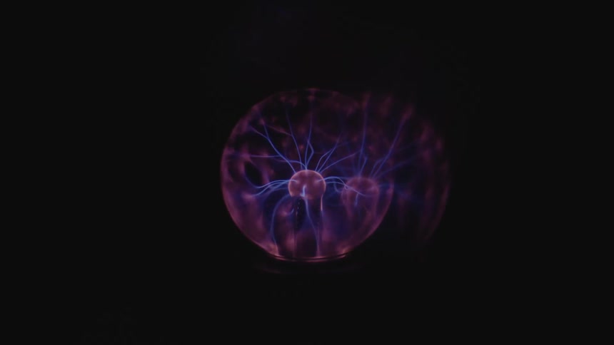 A globe of energy with purple lights and rays