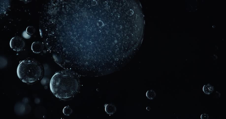 Bubbles floating on a liquid on a black background