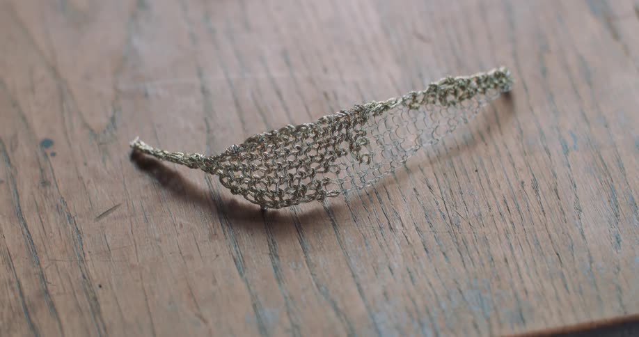 A withered leave with ash color on a wooden surface