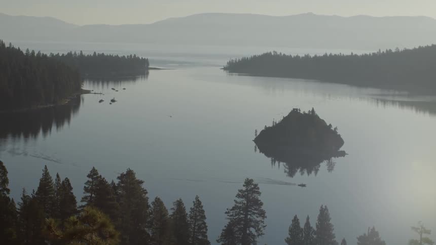 A large lake below is surrounded by forests