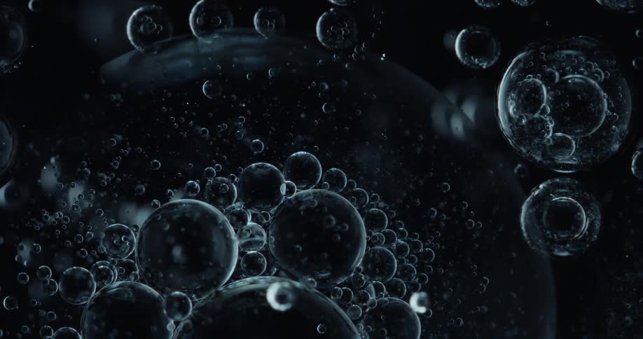 Air bubbles float over a dark background