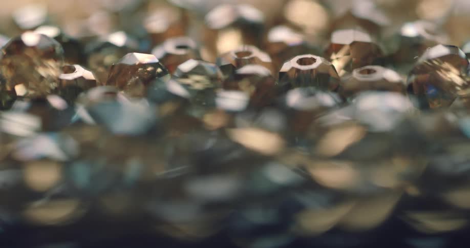 The camera focuses and becomes unfocused above a pile of beads