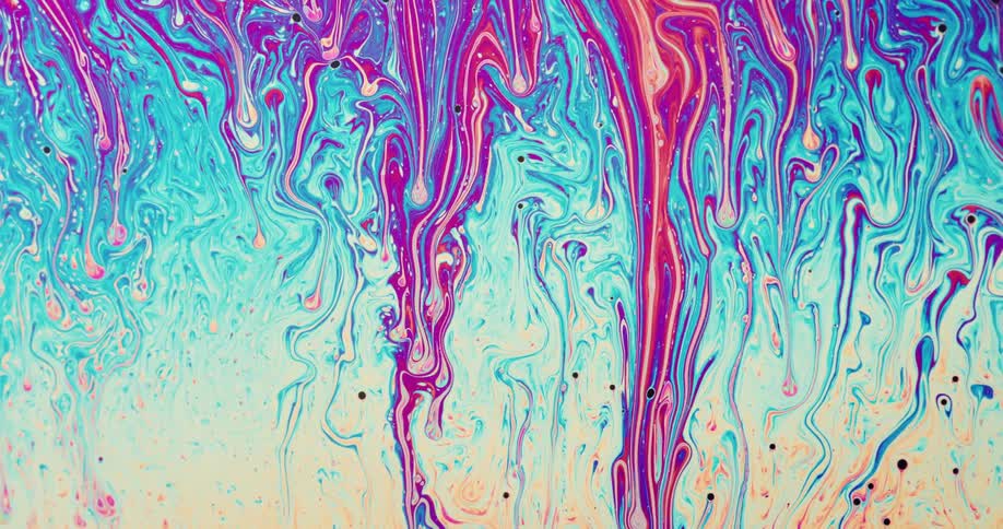 An abstract painting with colors running off the wall