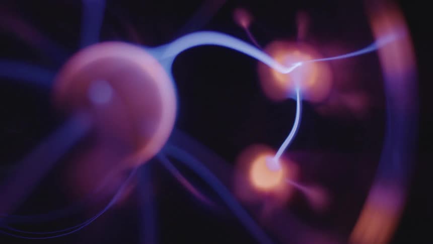 Glowing blue electric appendages extend from a pink sphere and connect to luminescent blobs as they move in the darkness