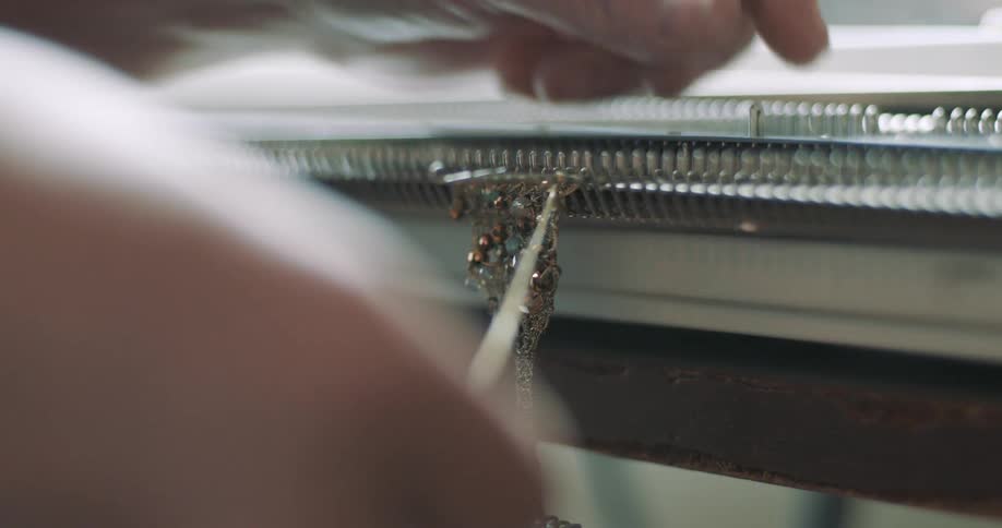 A person is making jewelry