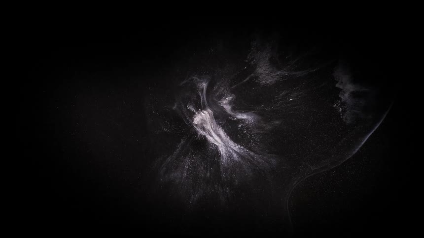 Lights and shapes resembling a glowing nebula shine in the darkness of space