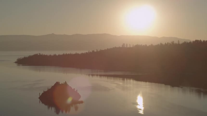 The sun is setting over the lake ahead
