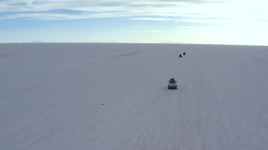 Vehicles are driving off road on the desert