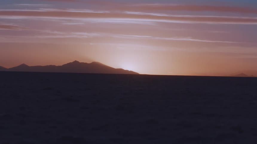 The sun setting behind a mountain