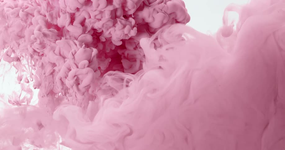 Cloud of bright liquid pink ink floats on a white background