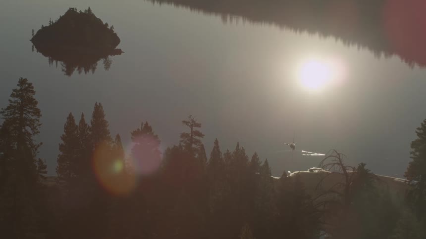 The sun is reflecting in the water of the lake below